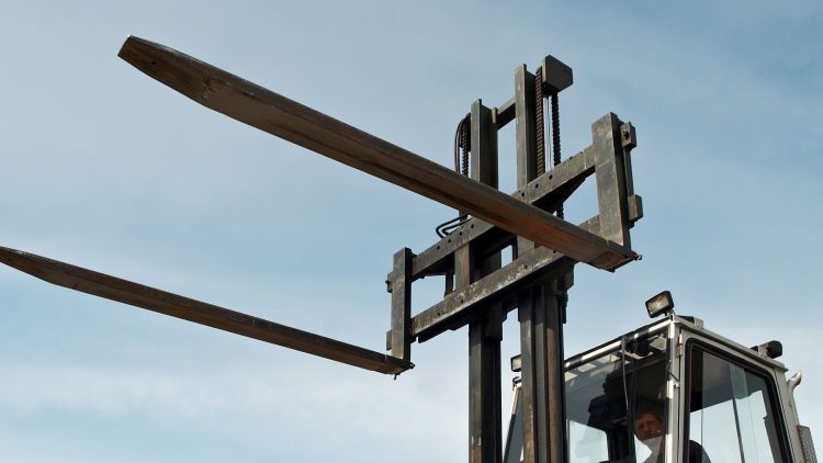 Used forklift forks with bends and cracks.