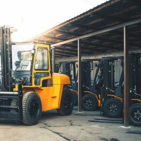 Large yellow rough terrain forklifts with pneumatic tires outside