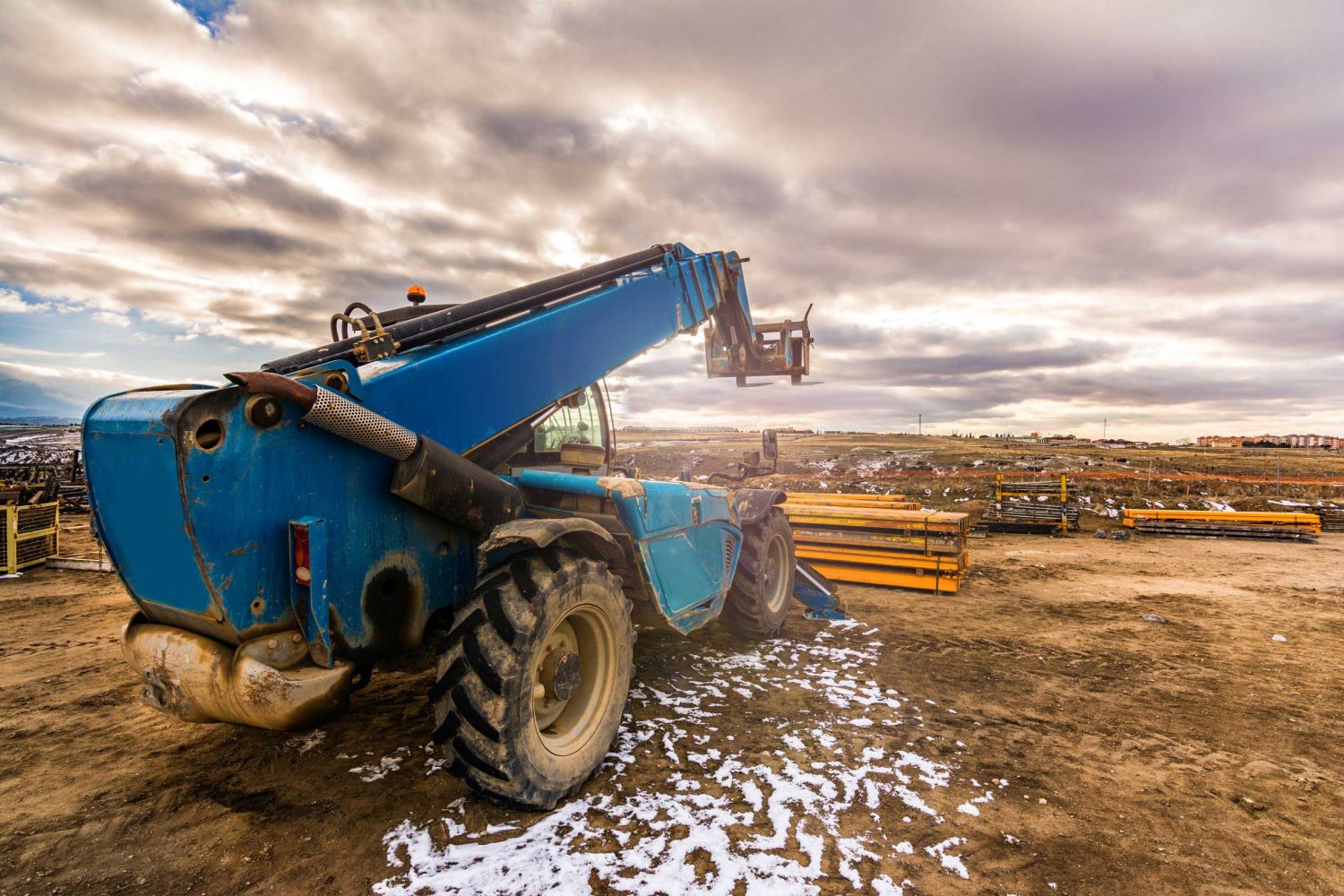 Large telescopic handler outside at an industrial site