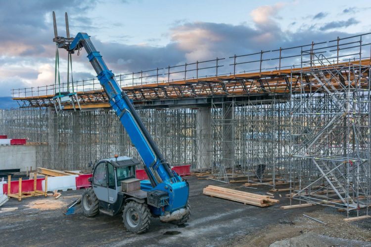Large extended zoom boom forklift outside at a construction site