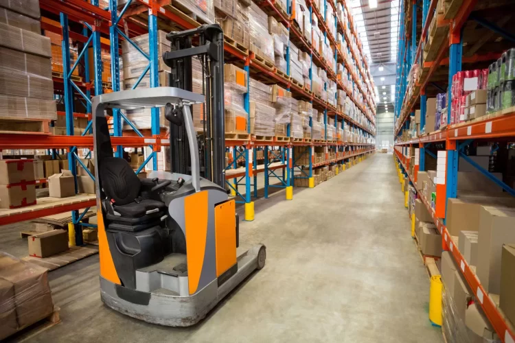 Small narrow aisle forklift in an organized warehouse aisle