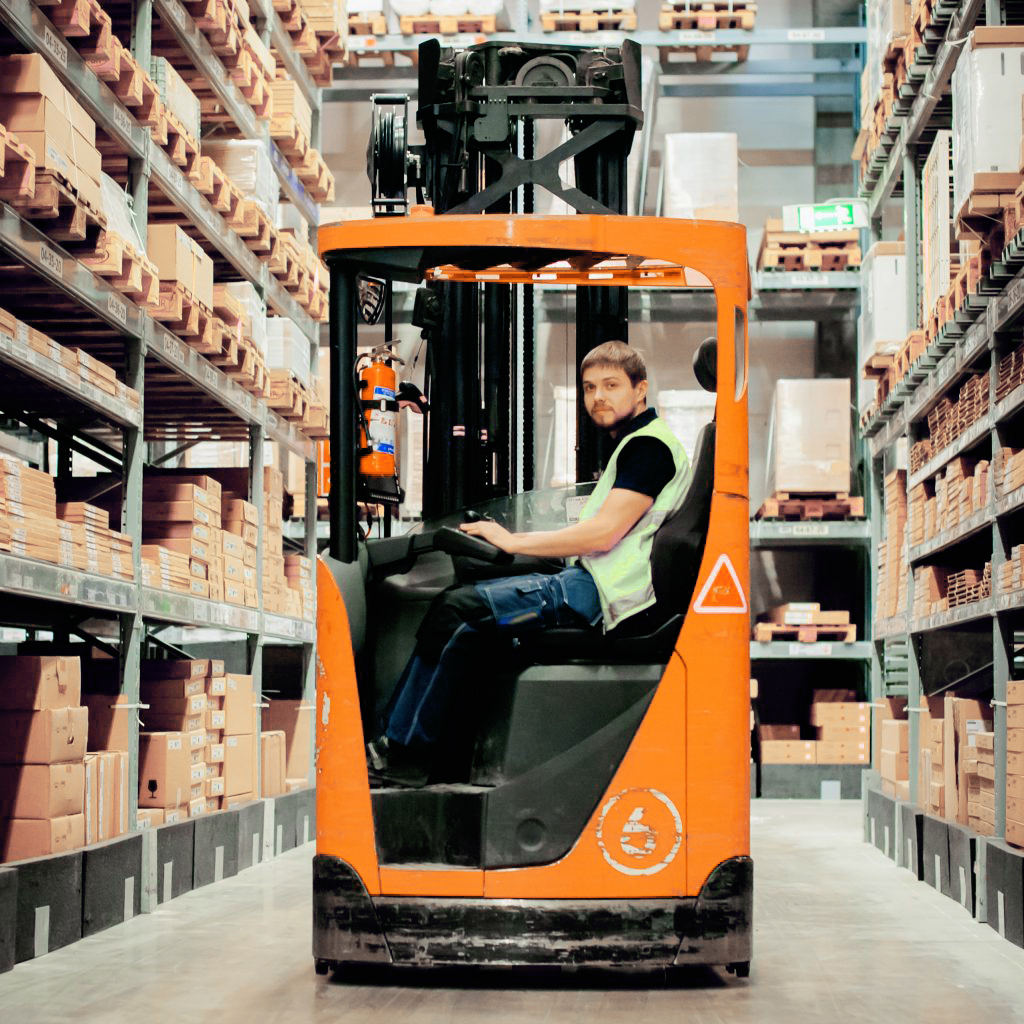 Very Narrow Aisle Forklift An employee operating a very narrow aisle forklift in a warehouse