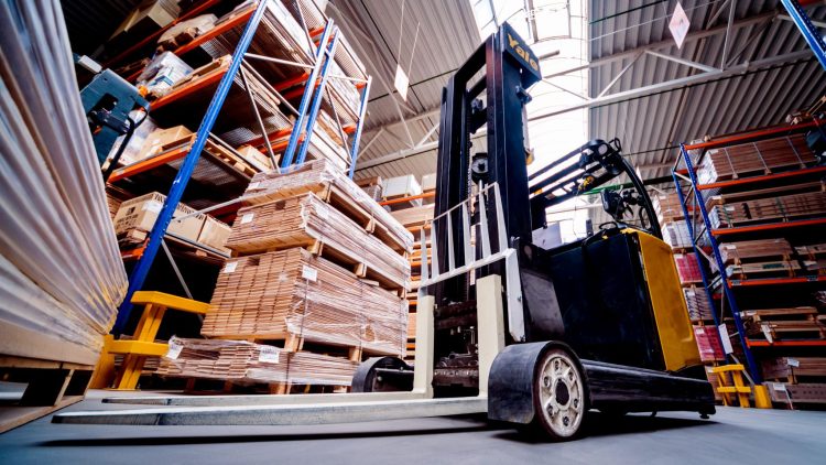 An operator showing how to reduce forklift damage in a warehouse