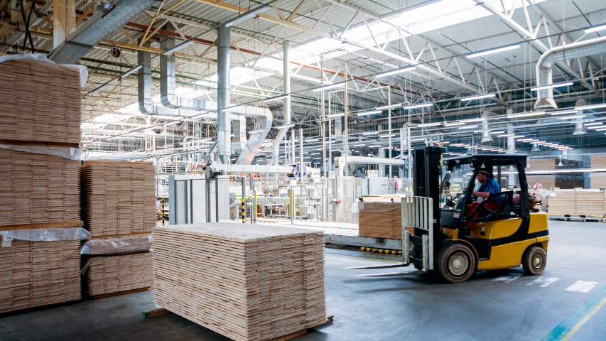 Forklift in warehouse moving pallets