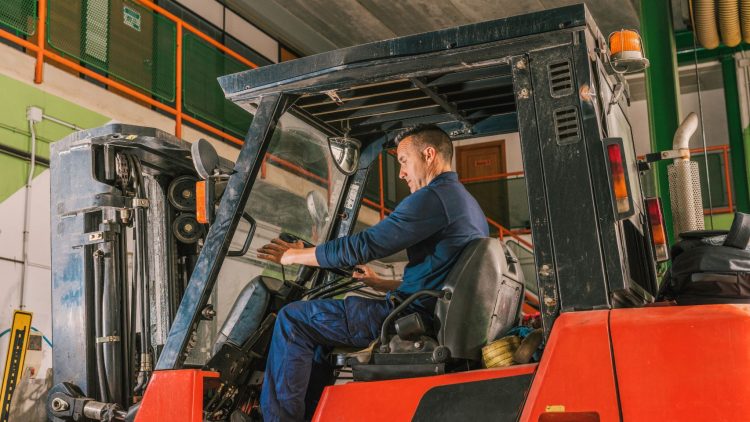Forklift operator following safe procedures