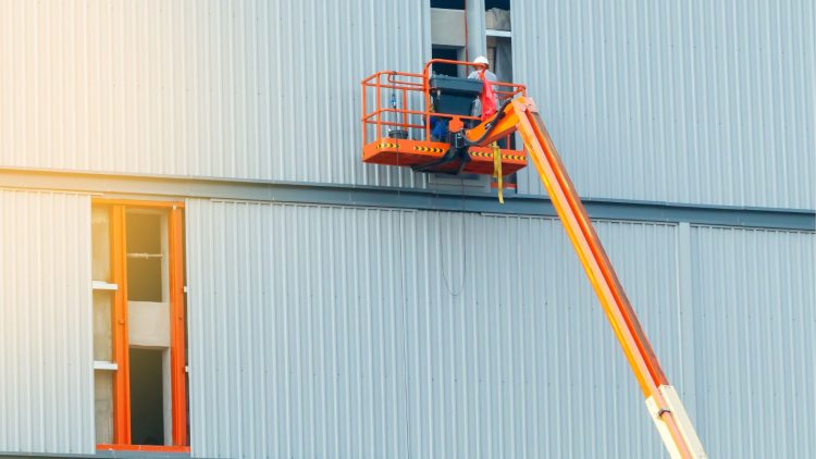 Men following OSHA boom lift safety requirements